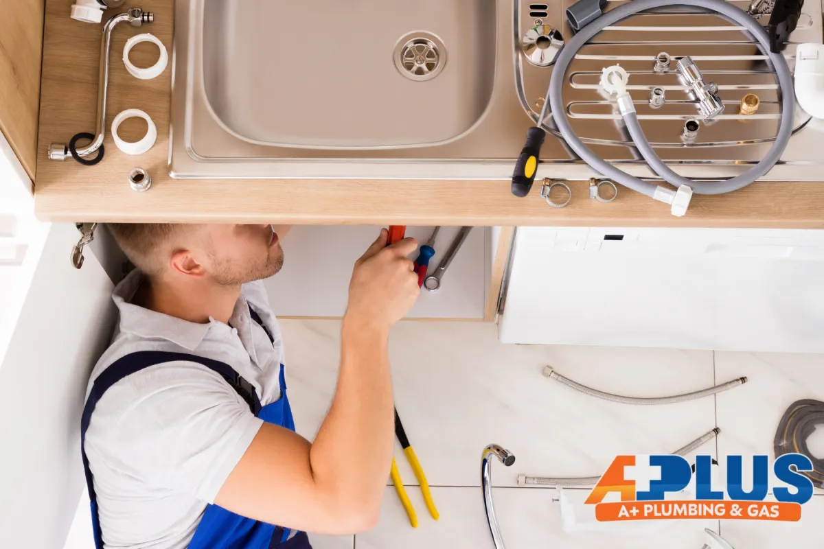 man repairing plumbing sink